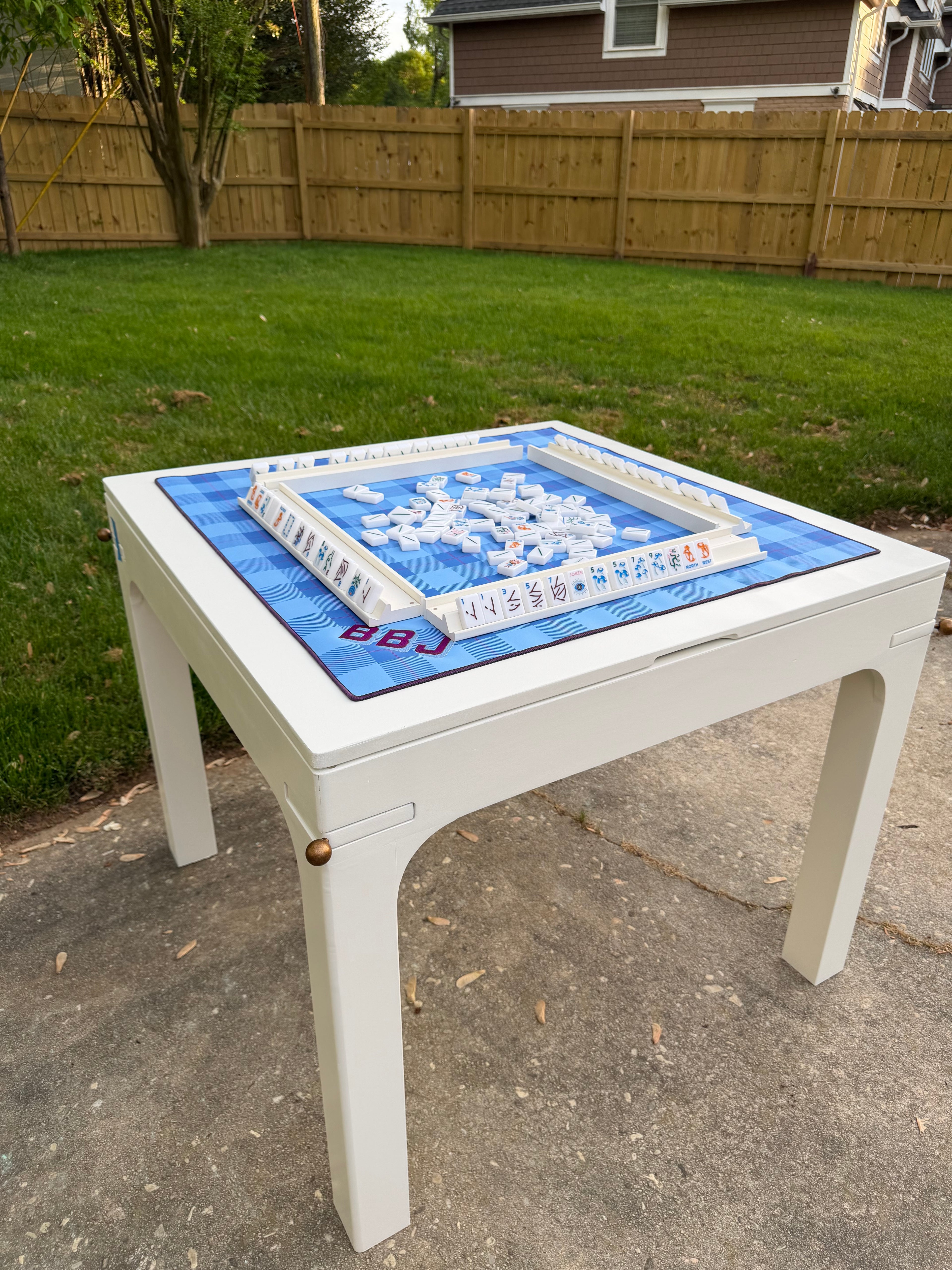 Drift Game Table – handcrafted wood mahjong table with sculptural arched legs, custom painted